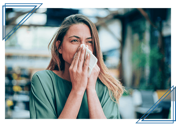 woman holding tissue to face