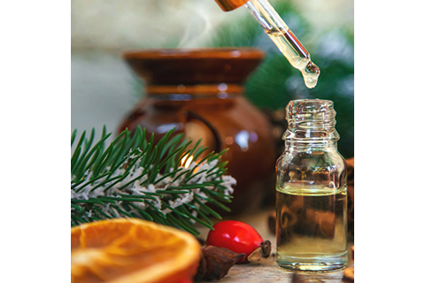 Essential oils and various spices arranged on a rustic wooden table